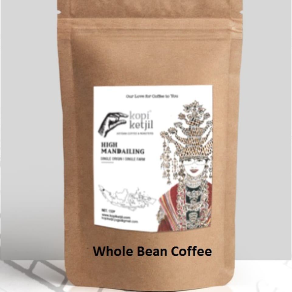 A brown bag of Kopi Ketjil High Mandailing whole bean coffee with an illustrated label.